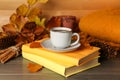 Composition with cup of hot coffee, books and autumn leaves on wooden table Royalty Free Stock Photo