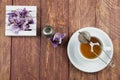 Cup of tea, tea accesories and dried leaves of orchids