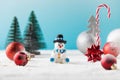 Snowman in hat and red baubles with traditional Christmas ornate on fake snow Royalty Free Stock Photo