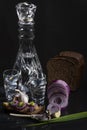 Composition with a decanter of vodka with chopped onions, garlic, bread, a herring sandwich and black bread Royalty Free Stock Photo