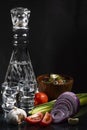 Composition with a decanter of vodka, two glasses, with chopped onions, garlic, chopped cucumber, tomatoes, a wooden plate with Royalty Free Stock Photo