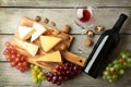 Composition of delicious cheese, grape, nuts and wine