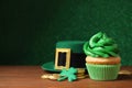 Composition with delicious decorated cupcake on table. St. Patrick`s Day celebration