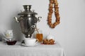 Composition with delicious ring shaped Sushki (dry bagels) and tea on white tablecloth near wall