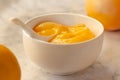 Composition with delicious Yellow lemons and Lemon curd in a sausepan white bowl on marble background Royalty Free Stock Photo