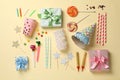 Composition with different birthday accessories on beige background