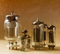 Composition of different electronic vacuum tubes on kraft paper background in warm colours. Royalty Free Stock Photo