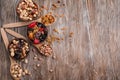 Composition with different kinds of nuts, dried fruits and berries on wooden background Royalty Free Stock Photo