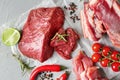 Composition with different sorts of fresh meat on grey background Royalty Free Stock Photo