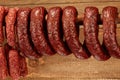 Many natural sausage hanged on wooden stick