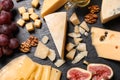 Composition with different types of delicious cheese and snacks on slate board Royalty Free Stock Photo