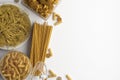 Composition of different types of dry and boiled pasta and spaghetti on a white background. Banner with copy space for text. A set Royalty Free Stock Photo