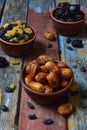 Composition from different varieties of dried fruits on wooden background - dates, apricots, prunes, raisins. Healthy food Royalty Free Stock Photo