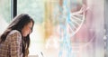 Composition of dna strand and medical data processing over female student Royalty Free Stock Photo