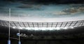 Composition of empty rugby stadium and rugby ball over clouds