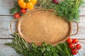 Composition with empty tray, different fresh herbs and vegetables on wooden background