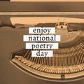 Composition of enjoy national poetry day text over typewriter