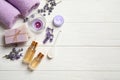 Composition with essential oil and lavender flowers on white wooden background. Space for text Royalty Free Stock Photo