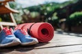 Exercise mat and trainers outdoors on a terrace in summer. Royalty Free Stock Photo
