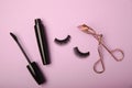 Composition with eyelash brush, eyelash curler, mascara and false eyelashes on background Royalty Free Stock Photo