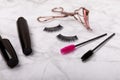 Composition with eyelash brush, eyelash curler, mascara and false eyelashes on background Royalty Free Stock Photo