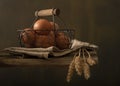 Composition with farm products. Basket of eggs, bunch of wheat ears.