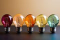 Composition featuring five colorful lightbulbs elegantly arranged on a tabletop.