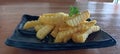 Indonesian Fried Snacks (Gorengan) and Crinkle-Cut French Fries on Black Plate Royalty Free Stock Photo