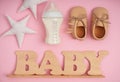 Composition with feeding bottle of baby formula and boots on color background Royalty Free Stock Photo