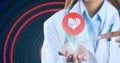 Composition of female doctor using virtual screen with heart icon over data processing Royalty Free Stock Photo