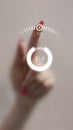 Composition of finger with pink nail pressing futuristic digital loading interface with progress circle Royalty Free Stock Photo