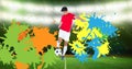 Composition of football player with ball over colourful splodges and sports stadium