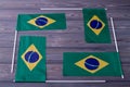 Composition of four brazilian flags on grey wood background.