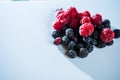 The composition of fragrant and delicious black and red raspberries on a white background are isolated in the studio Royalty Free Stock Photo