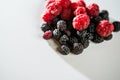 The composition of fragrant and delicious black and red raspberries on a white background are isolated in the studio Royalty Free Stock Photo