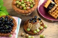 Composition of fresh berries of a black currant and gooseberry, on wood surfaces Royalty Free Stock Photo