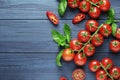Composition of fresh ripe cherry tomatoes, rammarine, basil and spices on blue wooden Royalty Free Stock Photo