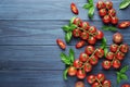 Composition of fresh ripe cherry tomatoes, rammarine, basil and spices on blue wooden Royalty Free Stock Photo