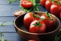 Composition of fresh ripe cherry tomatoes, thyme and spices on blue wooden Royalty Free Stock Photo