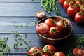 Composition of fresh ripe cherry tomatoes, thyme and spices on blue wooden Royalty Free Stock Photo