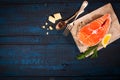 Composition with fresh salmon, herbs, parmesan and spices. Food background. Space for text Royalty Free Stock Photo