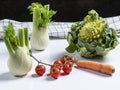 Composition of fresh vegetables with Roman cabbage, carrot, cherry tomatoes and fennel Royalty Free Stock Photo