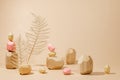 Composition of geometric balancing wooden stones and dried leaves. Concept of balance. Pastel background with copy space