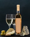 Composition with glass and bottle of white wine with blue mold cheese, pear and grapes on grey background. copy space Royalty Free Stock Photo