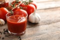 Composition with glass of tasty tomato sauce on wooden table Royalty Free Stock Photo