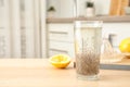 Composition with glass of water and chia seeds on table against blurred background, Royalty Free Stock Photo