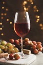 Composition with glass of wine and grape on brown background