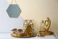 Composition with golden accessories on dressing table near color wall Royalty Free Stock Photo