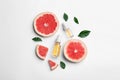 Composition with grapefruit slices and bottles of essential oil on white background Royalty Free Stock Photo