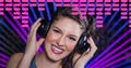 Composition on graphic music equalizer over portrait of smiling female dj holding headphones in club Royalty Free Stock Photo